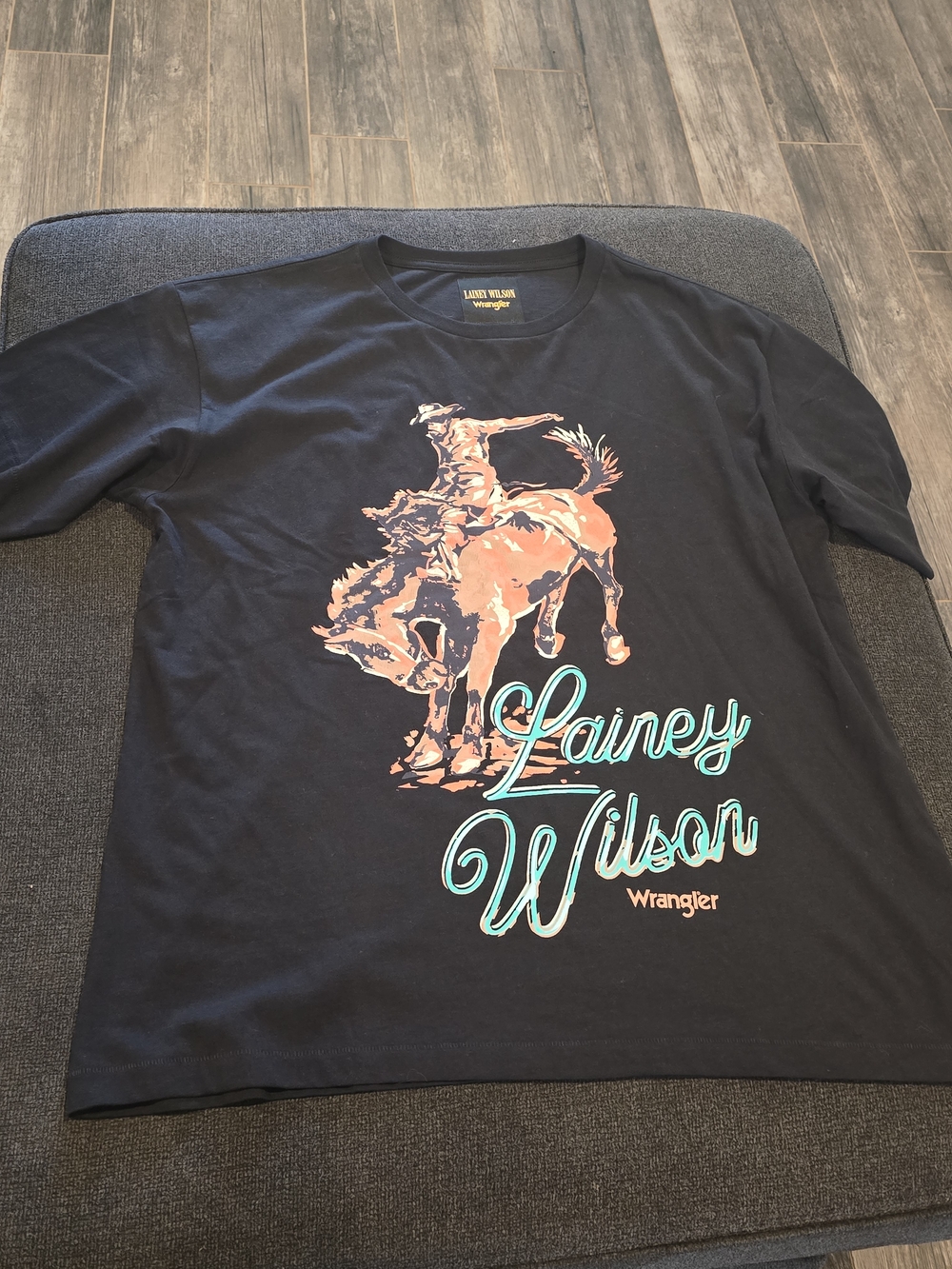 Wrangler Black Tee with Peach Rodeo Graphic and Teal Script